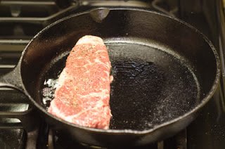 Raw steak in a super hot pan Raw steak in a super hot pan
