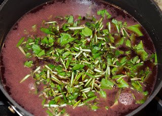 Red wine reducing with aromatic herbs