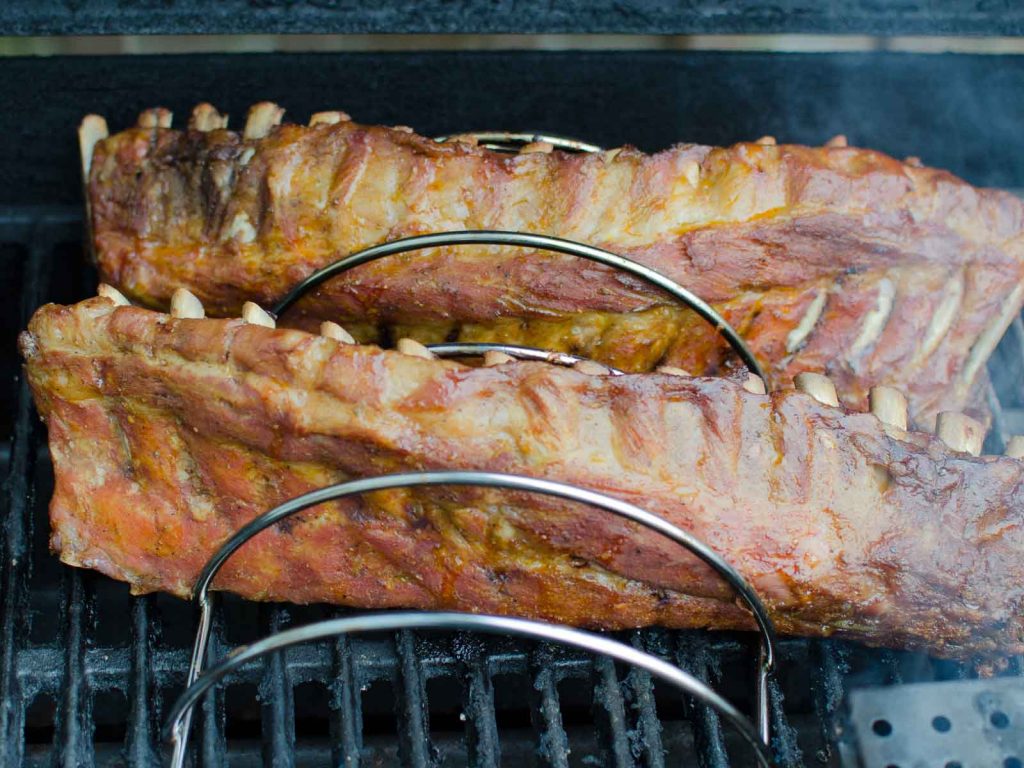 Texas Two Step Ribs on the grill in a rib rack