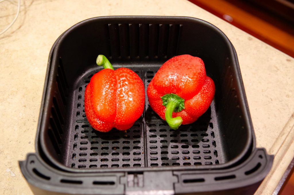 Red Peppers in an air fryer before roasting