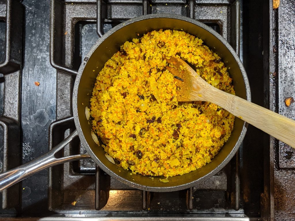 Savory Turmeric Couscous in a Sauce Pan after Fluffing